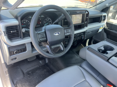 Ford F-450 cab and chassis interior showing steering wheel with controls, large touchscreen, and center console.