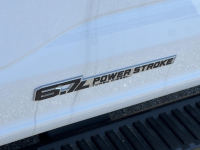 Ford F-450 cab and chassis badge showing Power Stroke Turbo Diesel badge on white body panel.