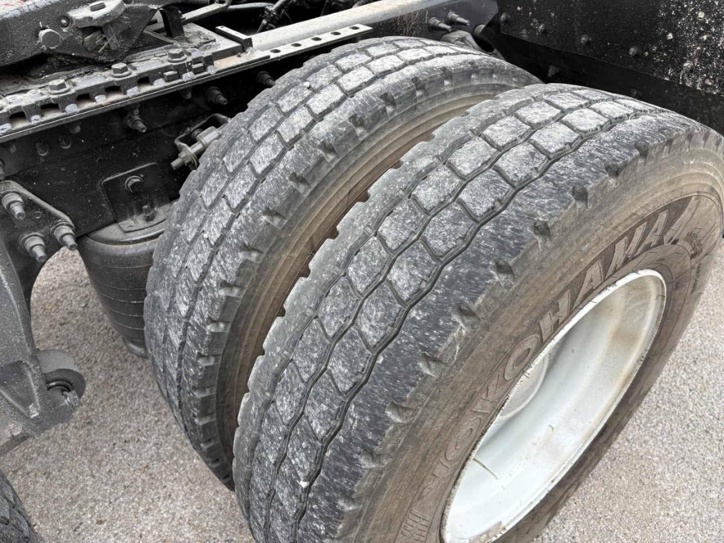 Truck rear dual tires and suspension components in view on a used 2019 International LT