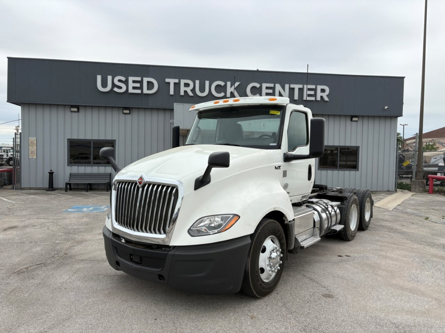 2019 International LT truck in front of Used Truck Center building showing daycab configuration and VIN plate.
