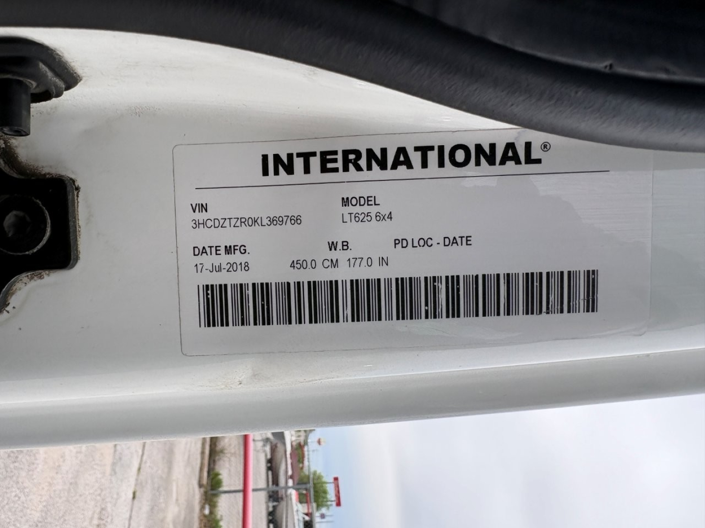 International VIN sticker on door jam showing VIN 3HCDZTZR0KL369766, MODEL LT625 6x4, DATE MFG 17-Jul-2018, WB/L 177.0 in, 4500 cm? 177.0 in wheelbase; barcodes beneath.