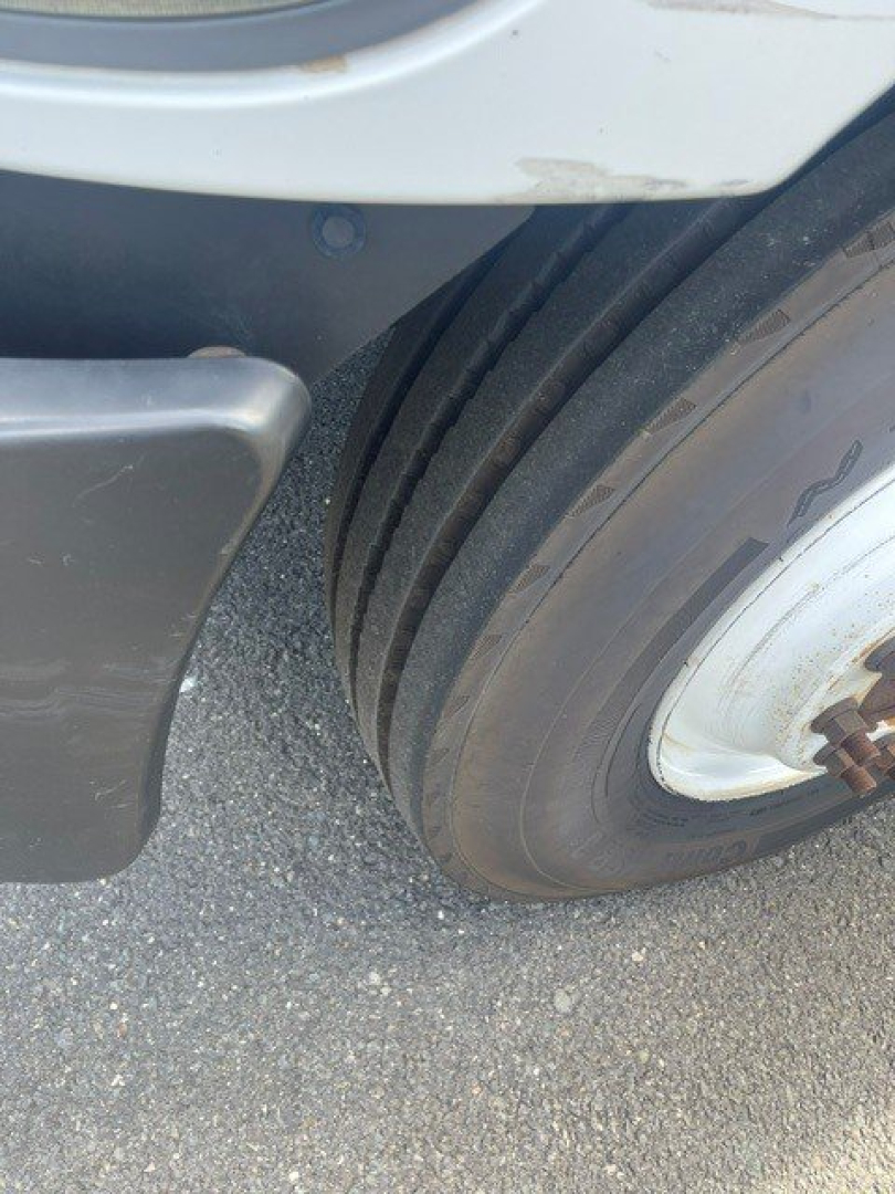 Hino 268 truck wheel and fender area showing dual rear tires and wheel well.