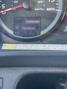 Dashboard of a used 2019 Hino 268 showing gauge cluster and digital fuel/maintenance display with warning sticker underneath.