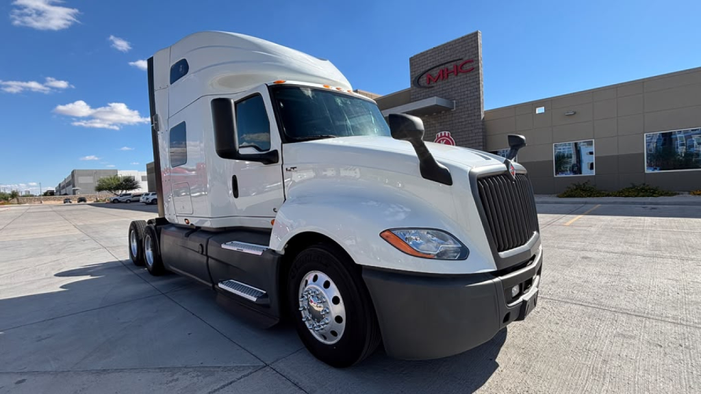 Truck cab of a white 2021 International LT625 conventional sleeper, front-right view, with black grille and side mirrors. No visible labels or stickers legible.