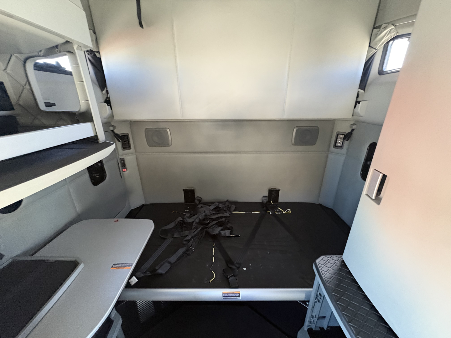 Kenworth truck cab interior showing sleeping area and bed platform in 2020 T680 with storage compartments and side shelves.