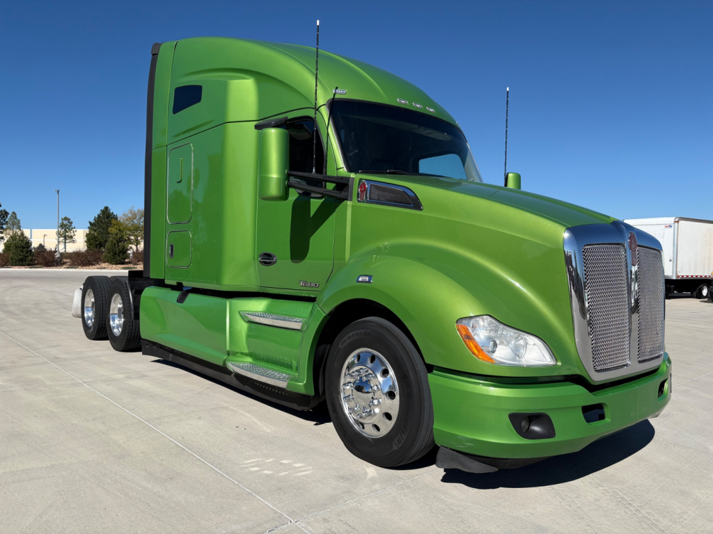 Green 2020 Kenworth T680 tractor cab in side view showing front grille, chrome bumper, and dual rear axles.