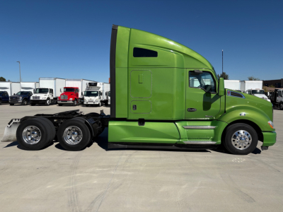 Green 2020 Kenworth T680 tractor shown in profile with sleeper cab, 6x4 rear axles, chrome wheels, and side fuel tanks.