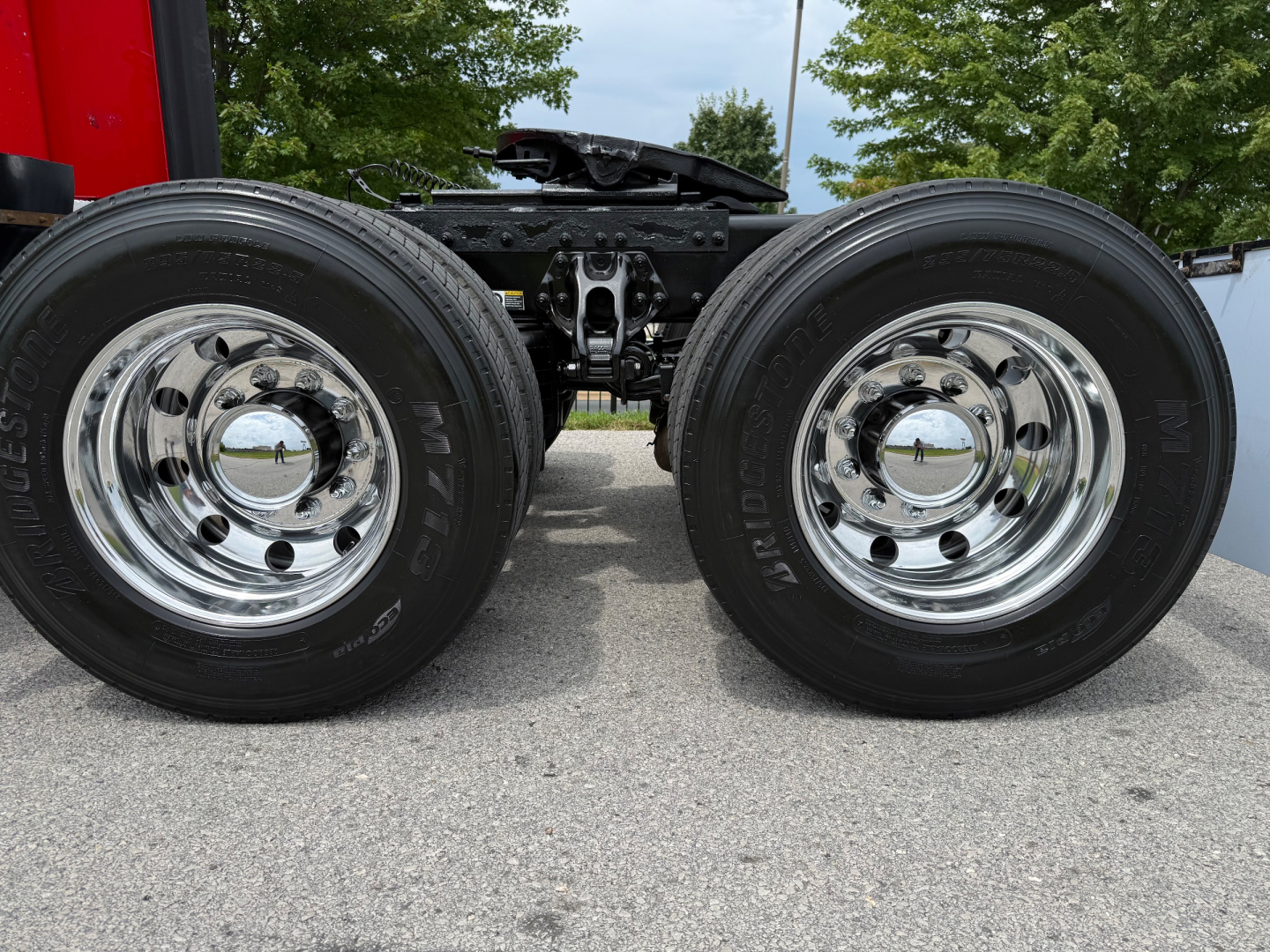 Dual rear axle with chrome wheels and black tires on Peterbilt 579 truck chassis showing wheel hubs and suspension components.