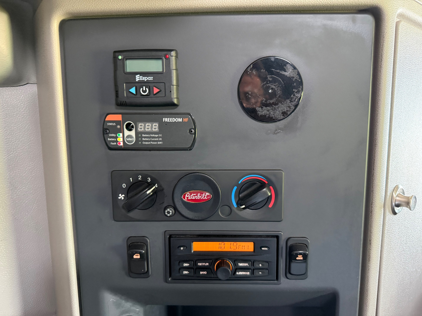 Conventional sleeper dashboard panel showing control modules and gauges in Peterbilt 579 interior.