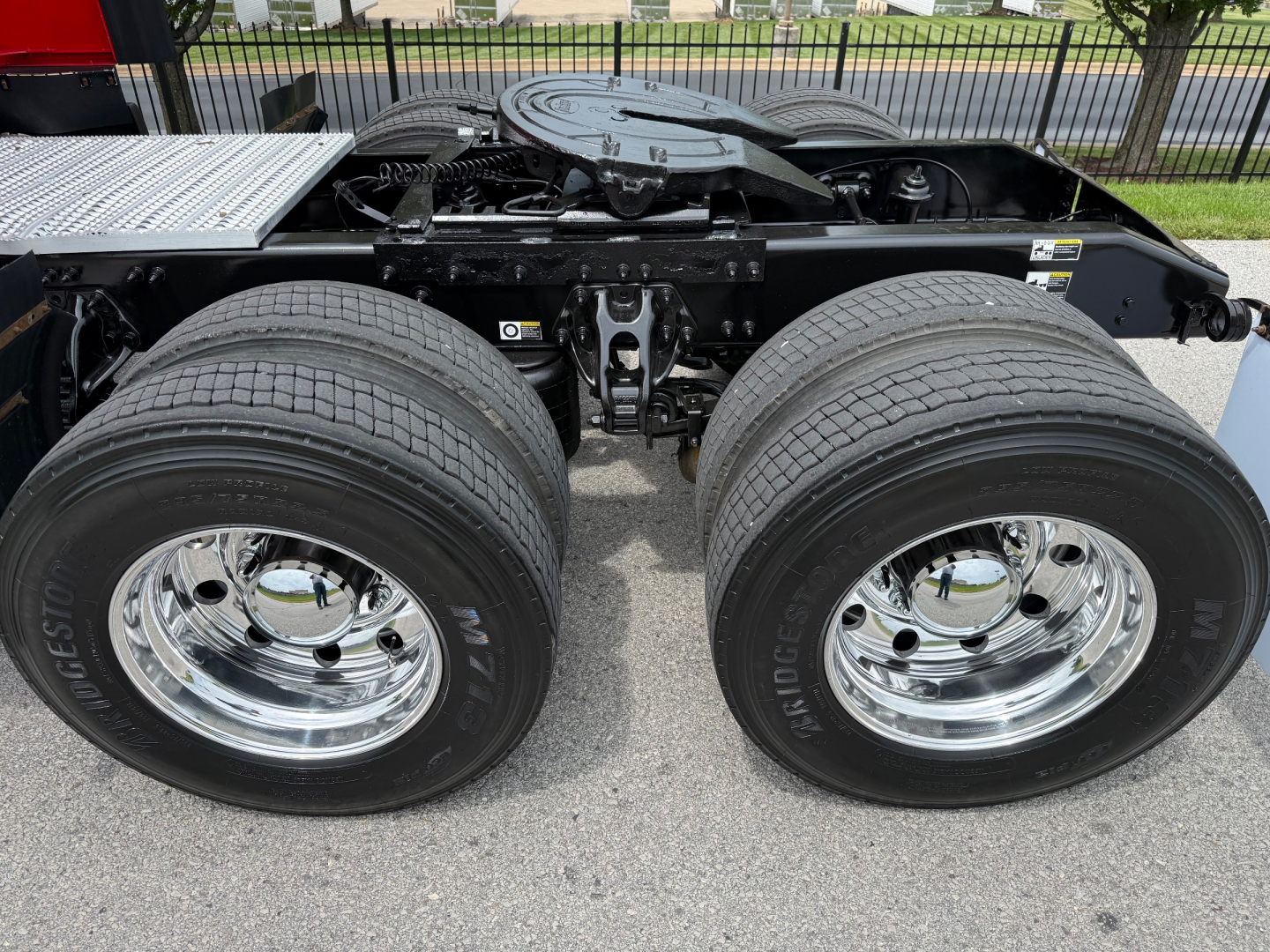 Peterbilt 579 tractor with dual rear axles and chrome wheels, chassis frame, and rear suspension visible