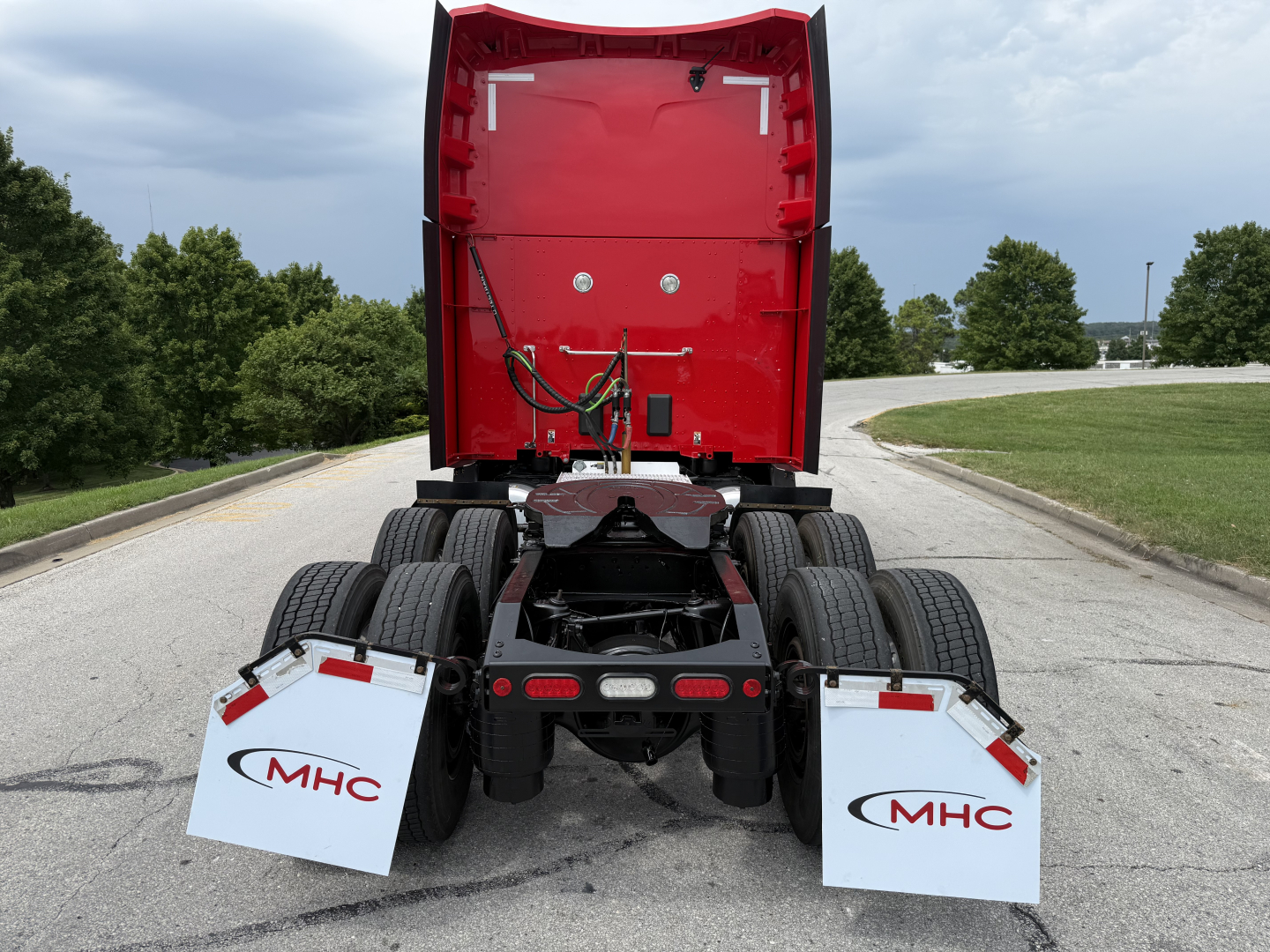 Peterbilt 579 rear view showing diesel truck chassis and mudflaps with MHC logos.