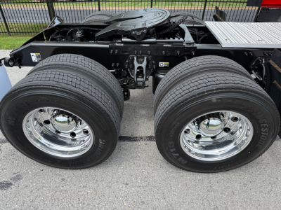 Peterbilt 579 chassis view showing dual rear axles with Michelin tires and chrome wheels, undercarriage frame and fifth wheel mounting plate visible.