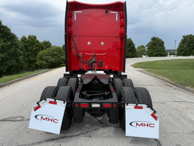 Peterbilt 579 rear view showing diesel truck chassis and mudflaps with MHC logos.