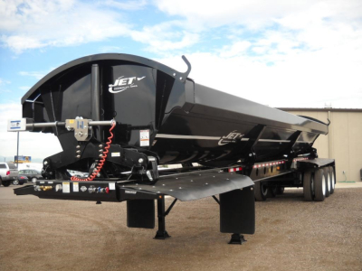 Jet Trailers Jet Quad/tri-axle side dump trailer showing hydraulic hose and front hitch assembly.