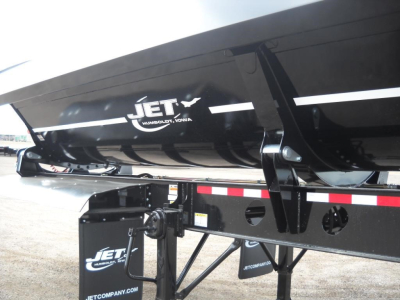 Jet.com side dump trailer tank showing Jet logo and structural frame with hydraulic supports and reflective stripes.