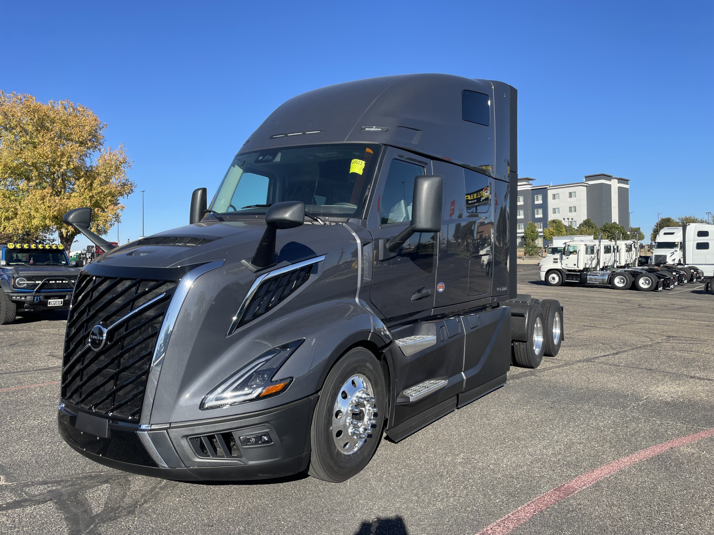 Volvo VNL64T660 sleeper cab truck front-left view with gray paint and chrome grille.