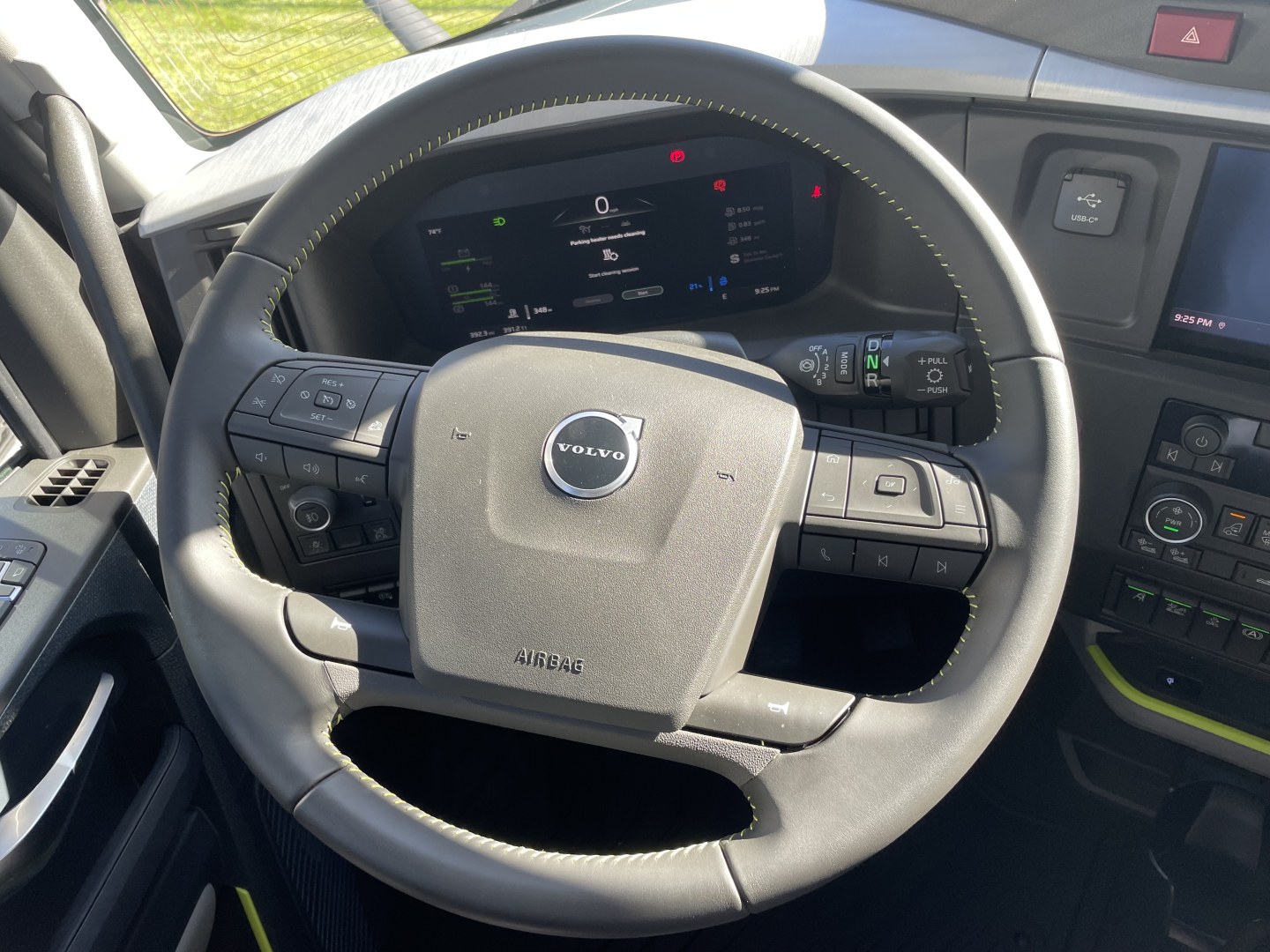 Volvo VNL64T660 truck interior showing steering wheel with Volvo logo and digital instrument cluster.