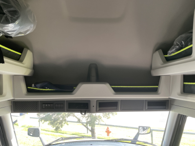 Cab interior top view of a new Volvo VNL truck showing overhead storage compartments and dash controls.