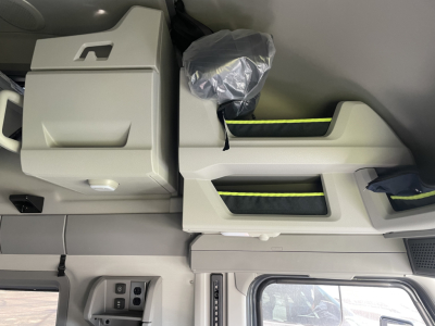 Cabin interior of a new 2026 Volvo VNL64T660 showing overhead storage compartments and sleeper bunk with light gray finish.