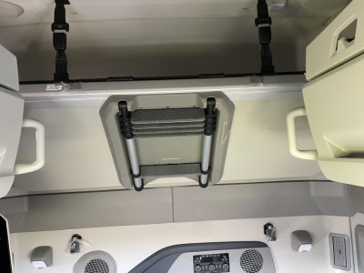 Volvo VNL64T660 sleeper cab area with overhead storage, ladders, and interior ducts; visible text includes VIN/stock on listing and interior components.