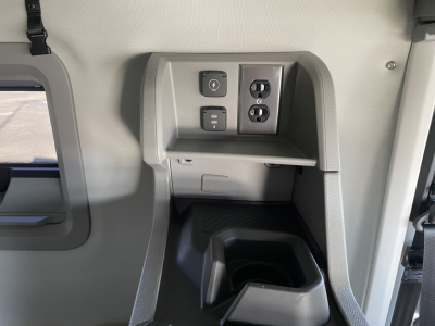 Volvo VNL64T660 interior panel showing auxiliary power and 12V/dual USB outlets and cup holder area