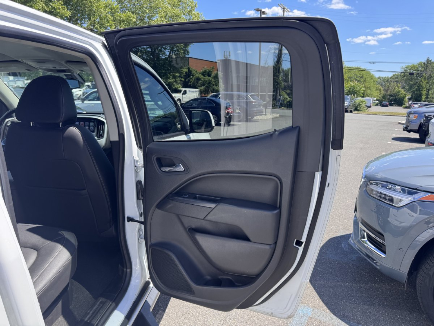 Chevrolet Colorado 2018 interior rear passenger door open showing black cloth seat and door panel.