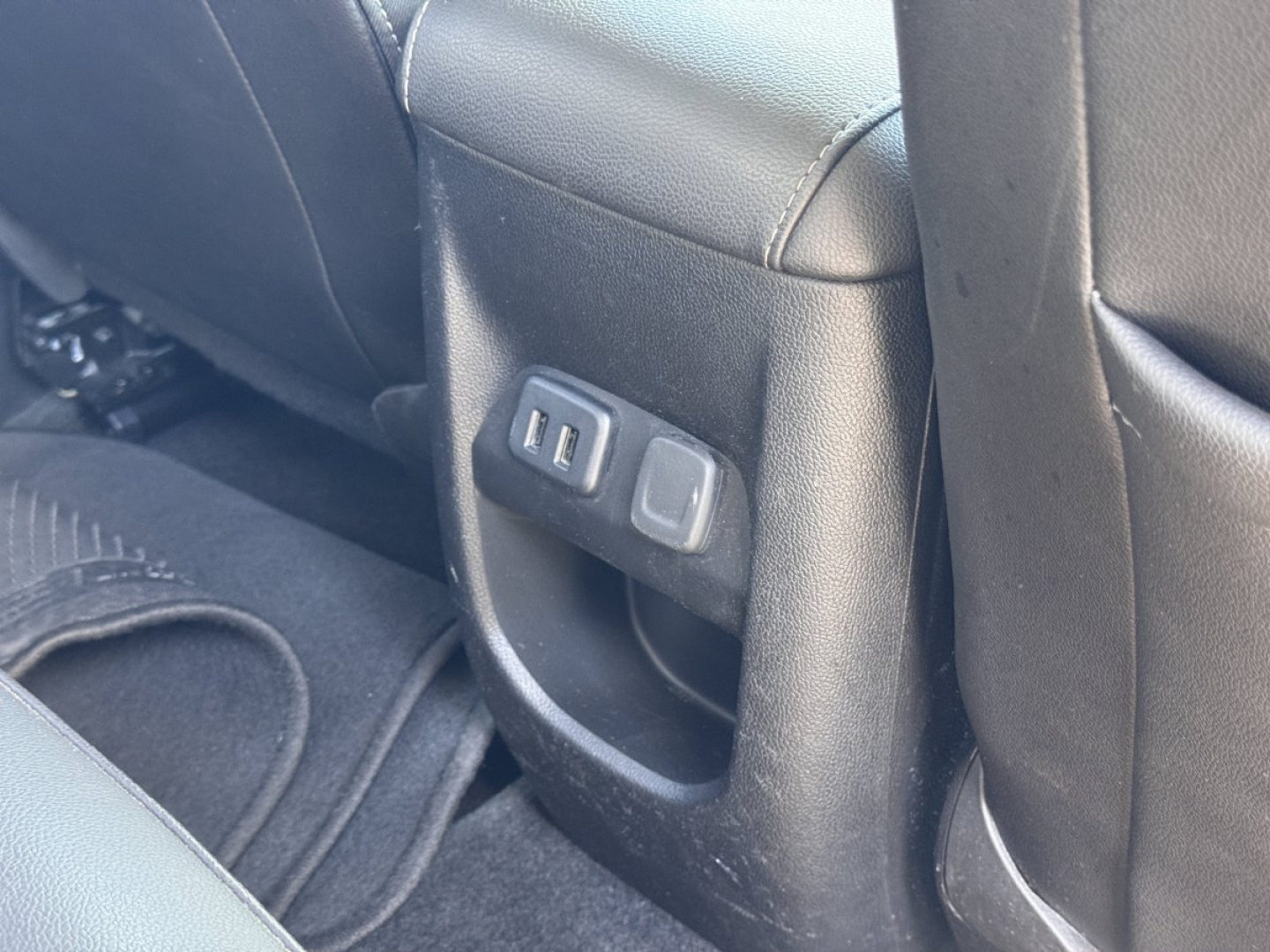 Chevrolet Colorado interior rear seat area showing center console with USB and power outlet ports.
