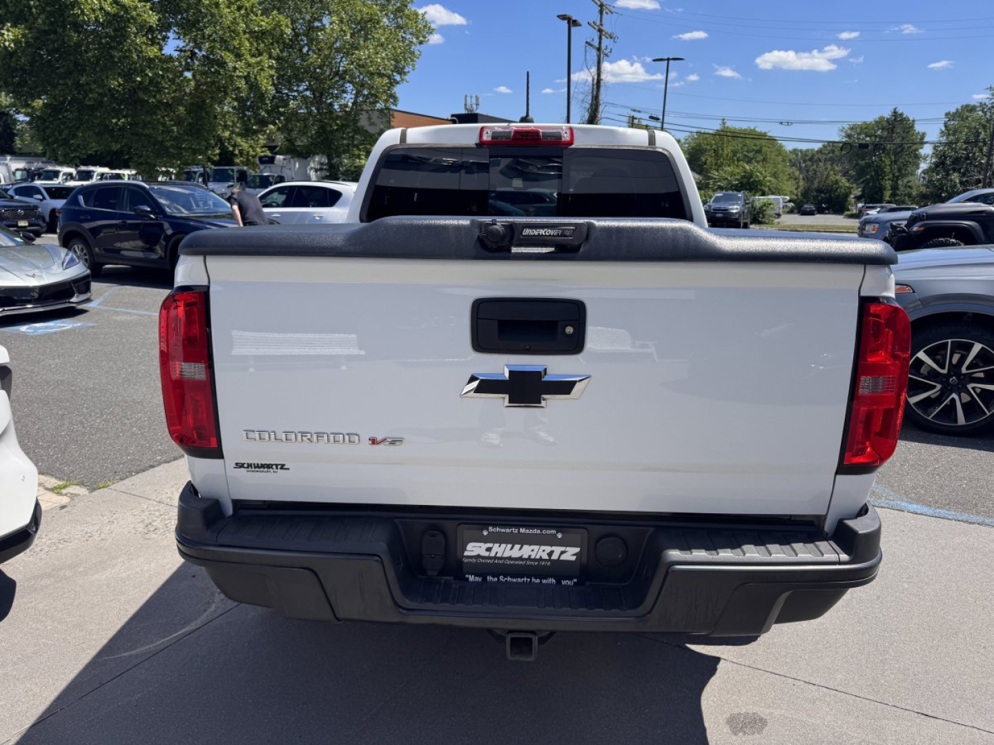 Chevrolet Colorado tailgate with Chevrolet bowtie emblem and model name, rear bumper, tail lights, and dealership plate area visible.