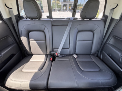 Back seat view of a 2018 Chevrolet Colorado showing black leather seats and center headrests.