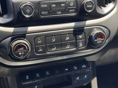 Chevrolet Colorado 2018 dashboard climate controls and center console with A/C, auto dual-zone, and media buttons visible.
