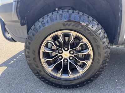 Chevrolet Colorado wheel close-up showing Goodyear Wrangler tire with alloy rim and Chevrolet emblem.