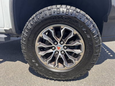 Chevrolet Colorado wheel and tire close-up showing alloy rim and Goodyear Wrangler tire with visible tread.