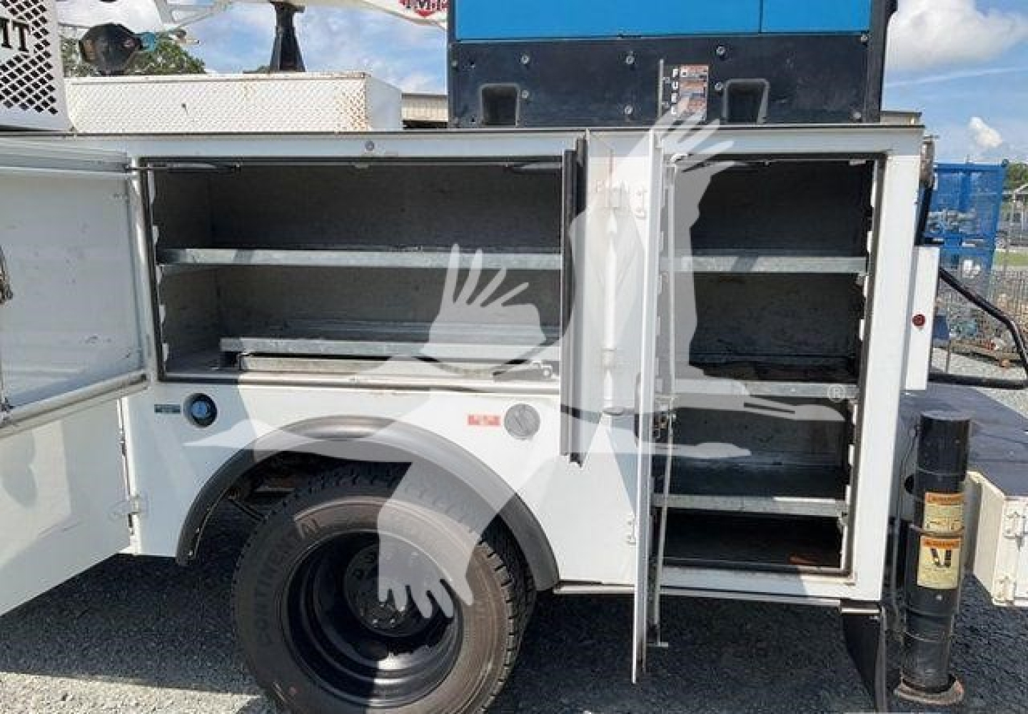 Ford F-550 service body with open compartments showing storage shelves and tool drawers.