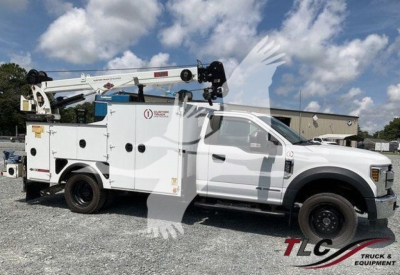 Ford F-550 service utility truck with utility body and crane, side view showing service compartments and lift arm.