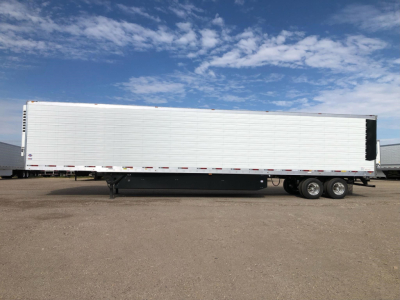 Trailer side view showing a long white refrigerated trailer with black undercarriage and wheels.