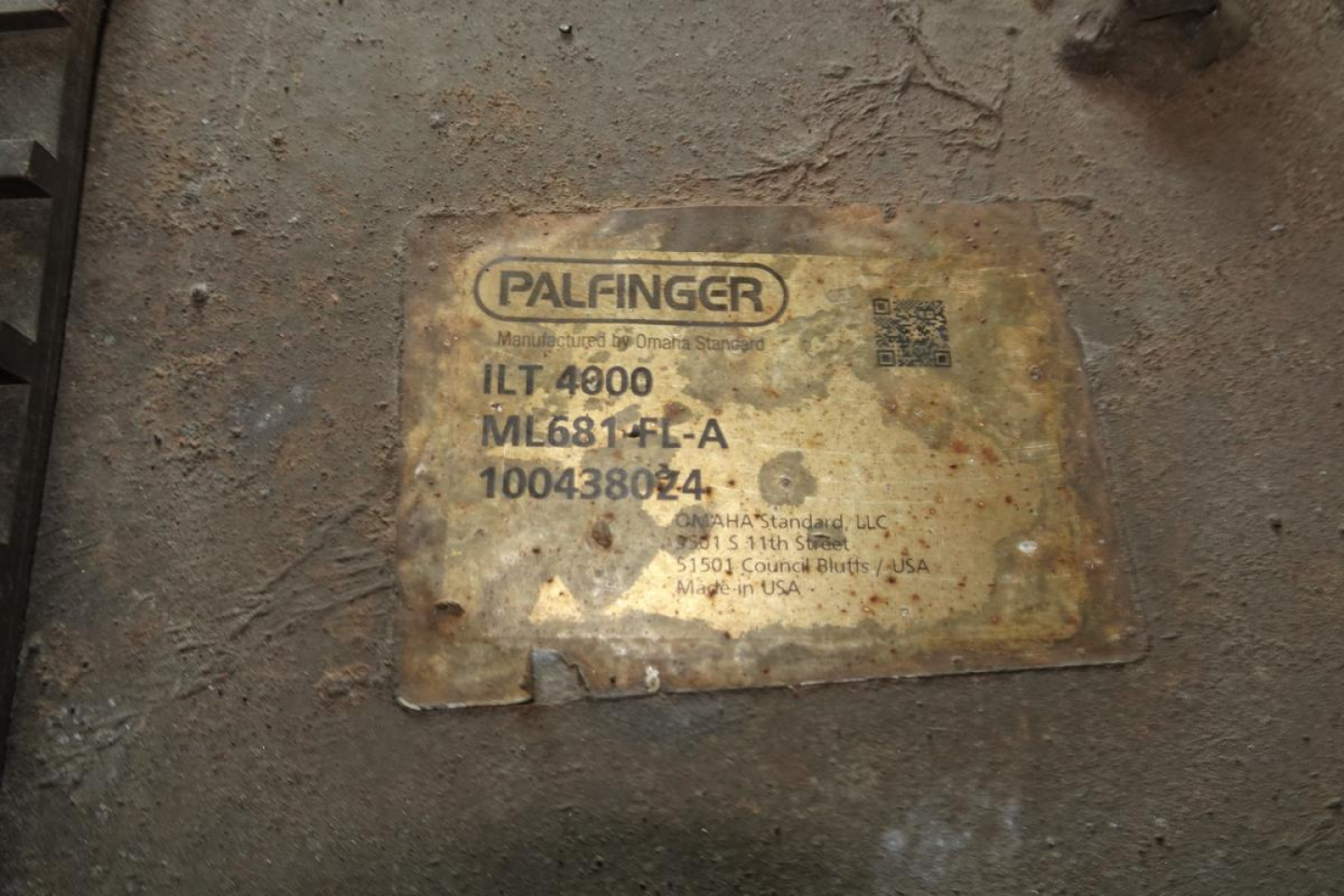 Palfinger label on a Freightliner M2 106 component plate showing ILT 4900 ML681-LL-A 100438024 with faded branding.