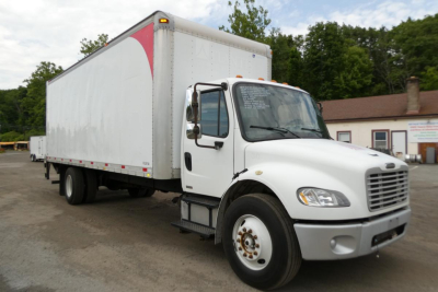 Box truck in side view showing Freightliner M2 106 cargo area and cab with white exterior.