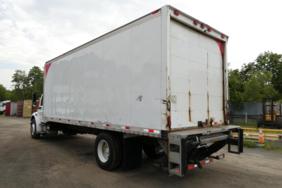 Box truck rear and side view showing cargo box on Freightliner M2 106 with lift gate and rear bumper.