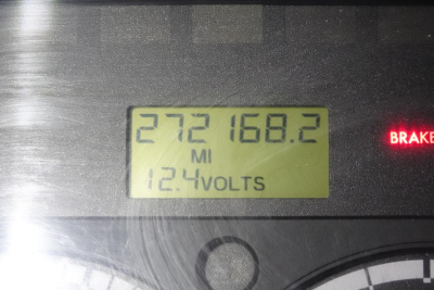 Dashboard display showing mileage 272168.2 miles and 12.4 volts in a Freightliner M2 106 cab, instrument panel with BRAKE warning
