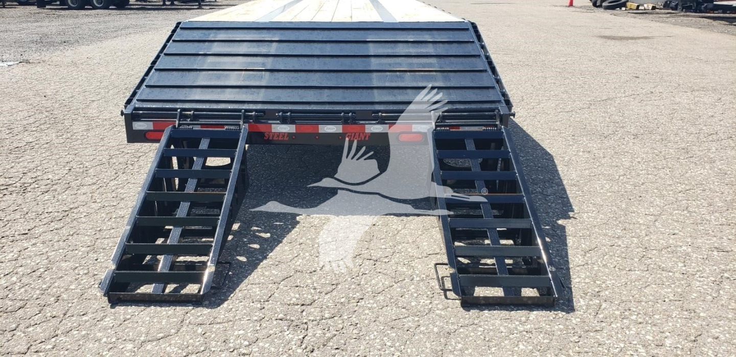 Beavertail dropdeck trailer rear view showing lowering ramps and steel deck, no visible branding text.