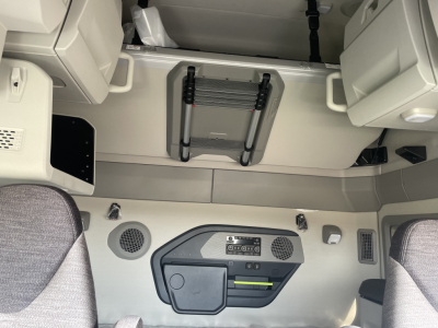 Volvo VNL64T660 cab interior showing overhead sleeper area and control panel with vents and storage shelves.