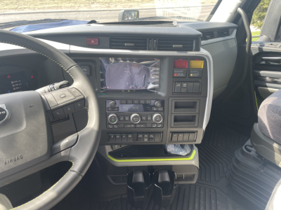 Volvo dashboard view showing center infotainment screen and control panel in a new Volvo VNL64T660 sleeper cab.