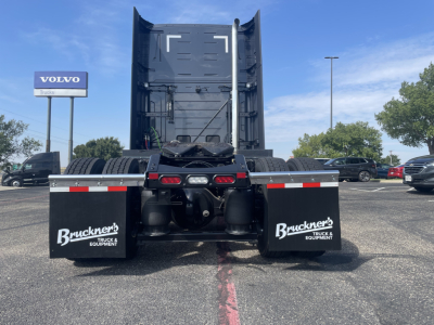Rear view of a new Volvo VNL64T660 sleeper tractor showing fifth wheel, twin rear axles, and mudflaps with Bruckner’s Truck & Equipment branding.