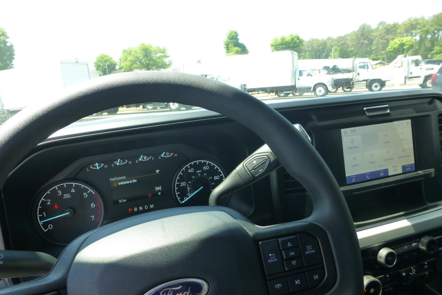 Ford F-250 interior dashboard with steering wheel and infotainment screen visible.