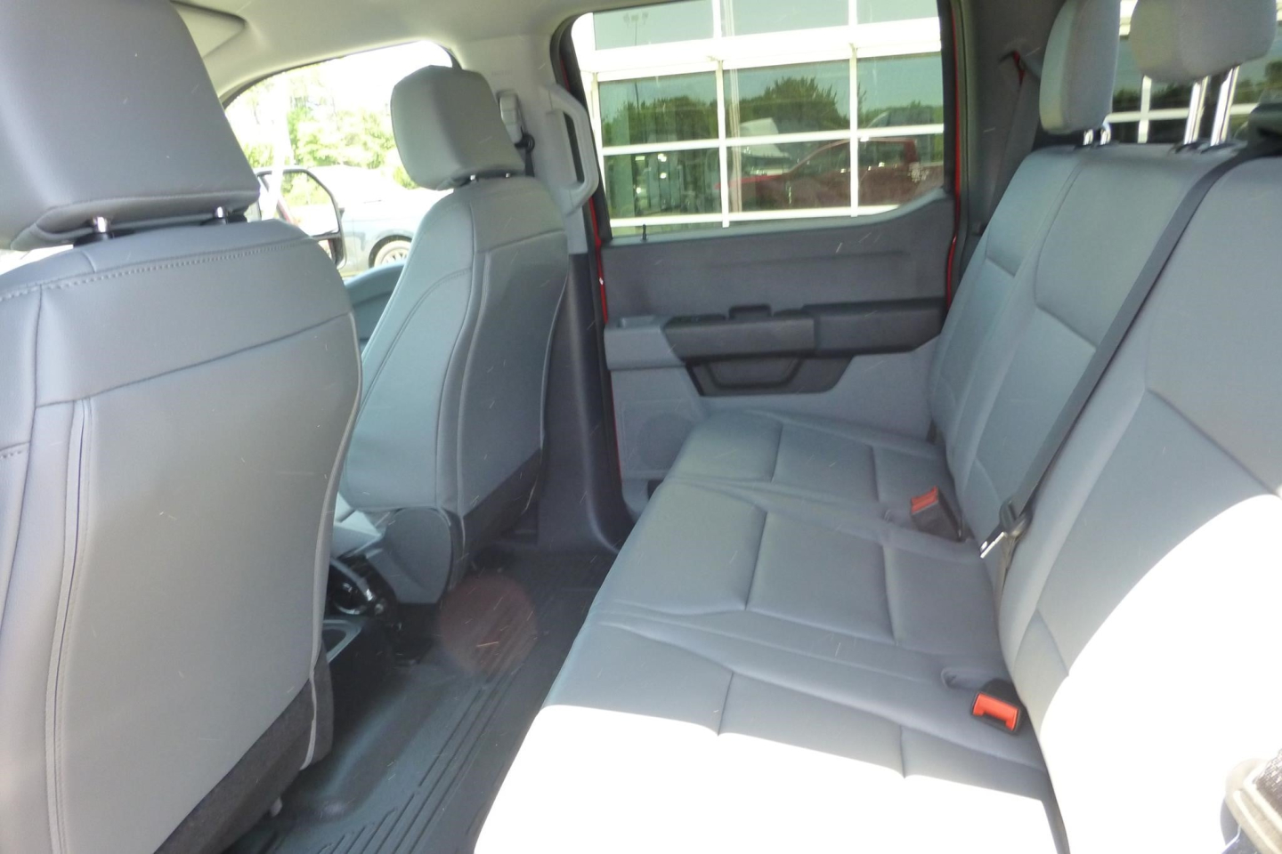 Ford F-250 Super Duty 2026 interior rear seating area showing gray cloth seats and rear door panels.