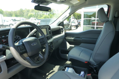 Front interior of a Ford F-250 pickup showing steering wheel, dashboard infotainment screen, and front seats.