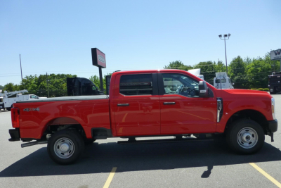 Ford F-250 Super Duty pickup truck side view showing extended cab, red paint, 4x4 badge, and dual rear wheels.