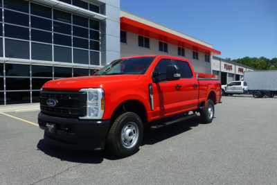 2026 Ford F-250 Super Duty pickup truck in red, front-side view, in dealership lot.