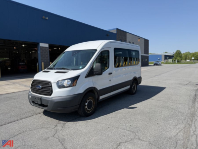 Ford Transit wheelchair van exterior side view showing white body, black trim, and disabled-access windows.