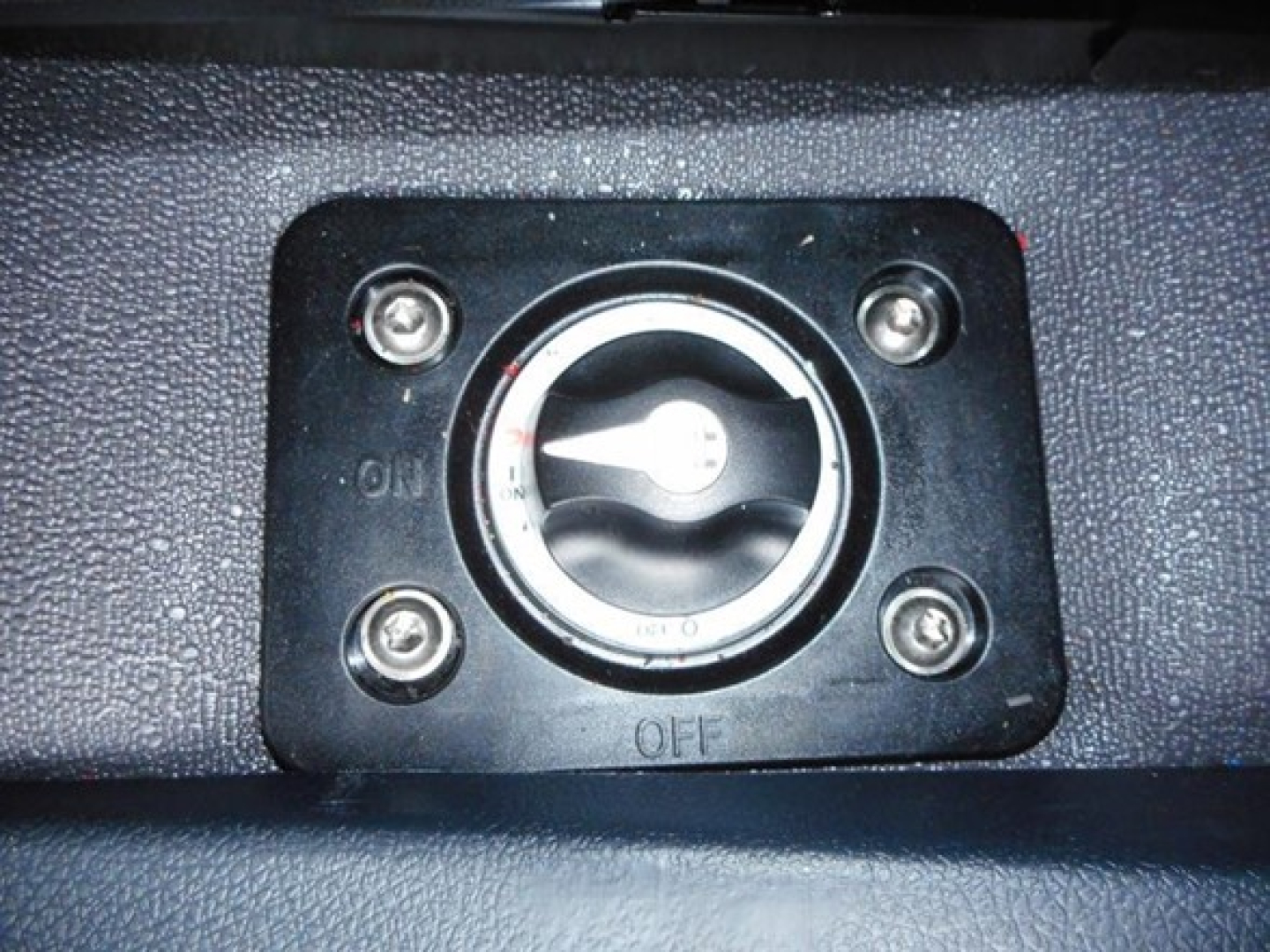 Freightliner Cascadia dash area showing ignition switch pocket with four screws and a circular lock/valve.
